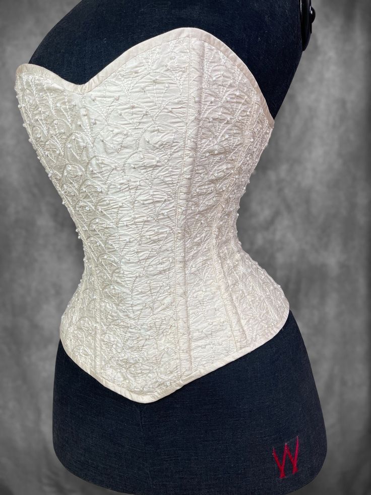 This listing is for the corset only The appeal of a corset is sensual and timeless. Embrace your inner Victorian goddess as you step back in time capturing the elegance of a bygone era. With our commitment to quality and a passion for authentic design our handcrafted corsets celebrate the beauty of the female form, effortlessly combing tradition with contemporary sensibilities. At Wicked lady all our designs are created from genuine historical sources. Inspired by late victorian corsetry this pi Overbust Corset With Boning And Fitted Bodice, Elegant Overbust Corset Belt With Boning, Elegant Overbust Corset Belt With Boned Bodice, Elegant Overbust Corset Dress With Corset Back, Elegant Satin Corset Belt With Fitted Bodice, Elegant Corset For Wedding Night, Strapless Corset Belt For Wedding, Elegant Wedding Corset Belt With Boning, Cream Corset Dress With Boned Bodice For Evening