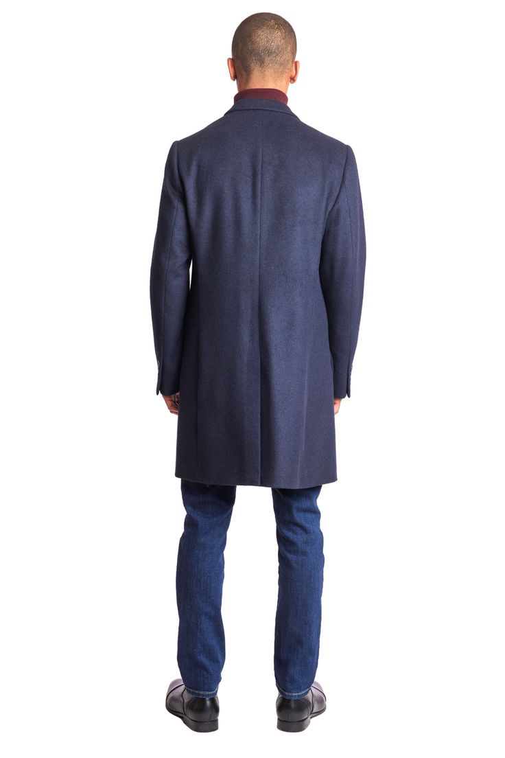 This dark navy soft touch Notch Topcoat is a timeless addition to any wardrobe. Crafted from a poly-wool blend, it features a classic notch collar, faux hair texture, and front pockets for practicality. Its navy hue and tailored fit make it appropriate for both formal and casual settings. This ensures you stay warm and stylish throughout the colder months.PRODUCT DETAILS: style 6495C slim-fitting long sleeve notch collar faux hair texture poly-wool blend dry clean only imported Classic Winter Outerwear With Pressed Crease, Winter Business Casual Outerwear With Pressed Crease, Formal Fall Peacoat With Pockets, Navy Wool Outerwear With Concealed Placket, Wool Outerwear With Notch Lapel And Pressed Crease, Navy Outerwear With Lapel Collar And Hidden Buttons, Classic Solid Outerwear With Pressed Crease, Fall Wool Outerwear With Pressed Crease, Tailored Navy Outerwear With Concealed Placket