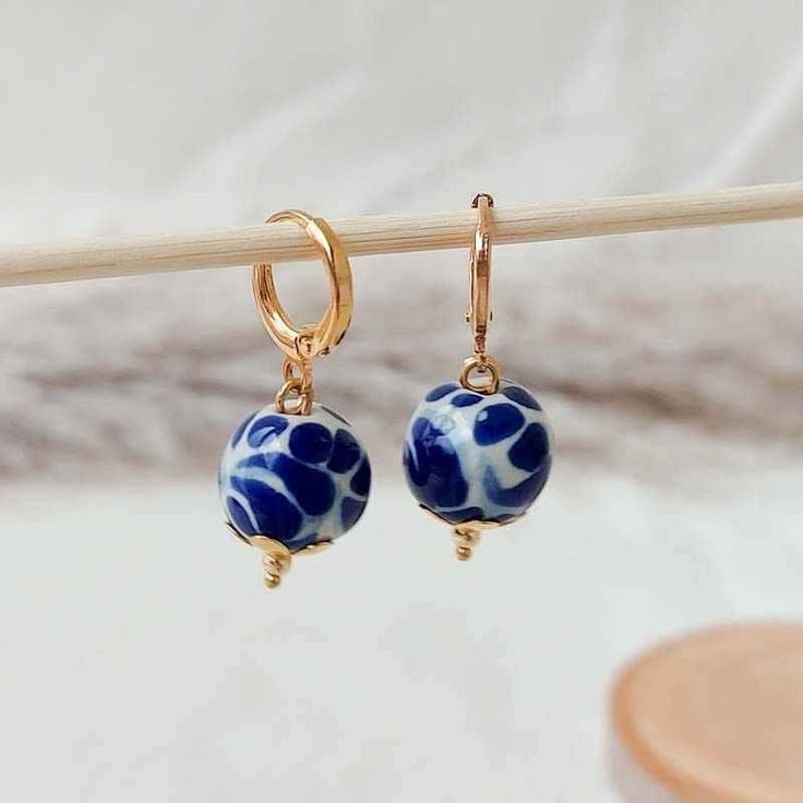 We combine art and elegance to create this beautiful piece. Our handmade earrings will be the perfect element to make your outfit standout. You could have the entire collection or gift them to someone special.  Material: Real Gold plate brass, Talavera gemstone  Dimensions: Drop Length 3cm, weight 2g Features : Lightweight, Unique and Simple design The Talavera of Puebla is part of the intangible heritage of humanity, declared by UNESCO. It is a type of majolica ceramic with a mixture of Chinese, Italian, Spanish, and indigenous techniques, and its colors are obtained from natural pigments. Its main characteristics are its vitreous finish and the use of bulky cobalt blue, this made it even more exclusive and ostentatious than Spanish craftsmanship. Its production requires at least 120 hour Artistic Gold Hoop Earrings As Gift, Artistic Gold Hoop Earrings For Gift, Handmade White Gold-plated Earrings, Dangle Beaded Brass Earrings For Gifts, Beaded Dangle Brass Earrings For Gifts, Gift Brass Beaded Dangle Earrings, Beaded Dangle Earrings In Brass As A Gift, Nickel Free Gold Plated Clip-on Earrings Gift, Handmade Dangle Plug Earrings As Gift