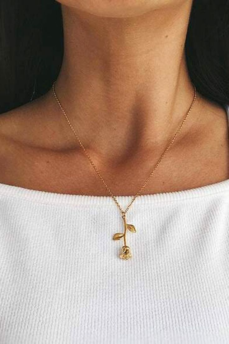 Woman wearing a gold rose stem necklace. Rose Gold Pendant Flower Necklace With Clavicle Chain, Rose Gold Flower Pendant Necklace With Clavicle Chain, Rose Gold Clavicle Chain Flower Pendant Necklace, Rose Gold Flower Pendant Necklace With Delicate Chain, Elegant Rose Design Charm Necklace For Gift, Elegant Rose Design Charm Necklace Gift, Feminine Rose Gold Necklace With Flower Charm, Dainty Rose Gold Flower Necklace With Clavicle Chain, Delicate Rose Gold Flower Necklace With Clavicle Chain