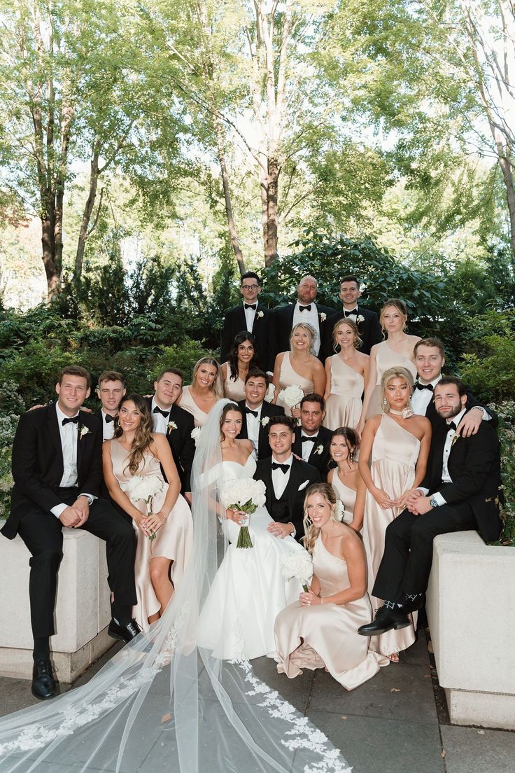 a group of people in formal wear posing for a photo