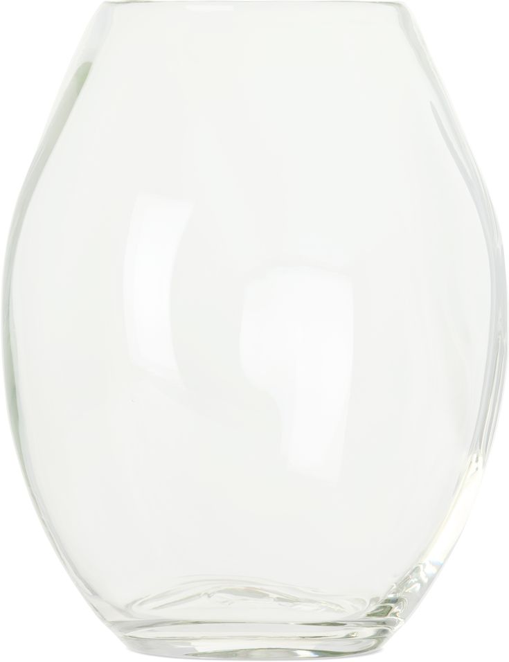 an empty glass vase sitting on top of a white table