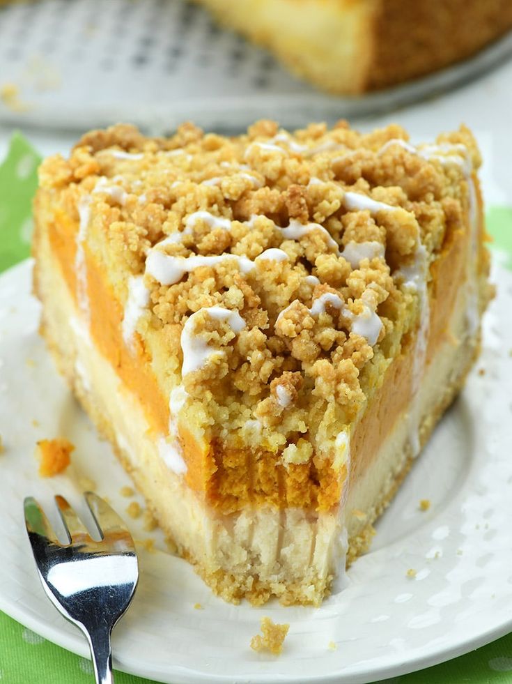 a piece of cake on a plate with a fork next to it and another pie in the background