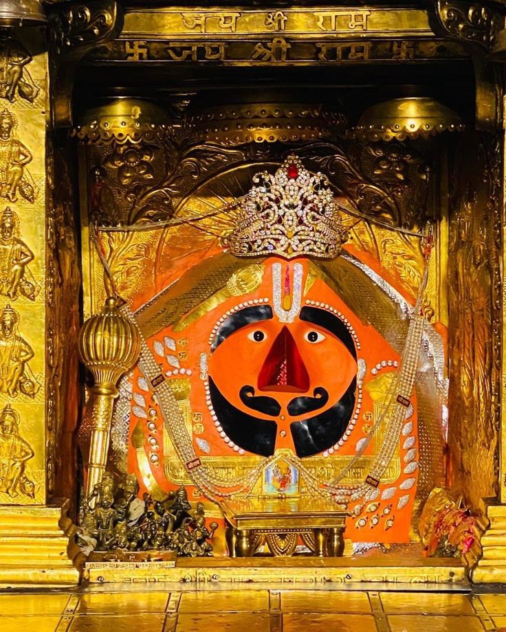 an elaborately decorated shrine in the middle of a room with gold and red decorations