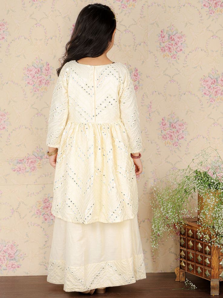 Viscose Cream Mirror Traditional Sibling Set Beautiful viscose cream colored sibling set featuring traditional mirror work embroidery. Perfect for festive occasions or special outings. Key Features Viscose fabric for a soft and comfortable feel Cream color with traditional mirror work embroidery Perfect for siblings to wear together Specifications straight shape regular style Mandarin collar, long regular sleeves Material & Care 100% Viscose Hand wash cold, gentle cycle Line dry in shade Iron on Beige Party Set With Mirror Work, Beige Party Sets With Mirror Work, Festive Off White Straight Kurta Set, Festive Off White Sets With Straight Kurta, Festive Off-white Sets With Straight Kurta, Festive Beige Straight Kurta Set, Cream Embroidered Sets With Traditional Drape, Festive Beige Sets For Eid, Festive Off-white Gota Work Sets