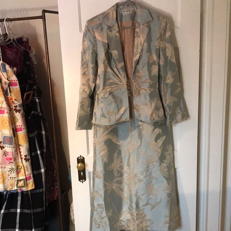 This Skirt Suit Is So Beautiful And In Excellent Condition. Light Blue With Ivory Florals Woven Into The Fabric 100% Silk Brocade. Lily, Pansy, Tulip, Solomon Seal, And Either Hydrangea Or Azalea Blossoms. This Would Be Perfect For A Wedding, A Vow Renewal, Mother Of The Bride, Fancy Easter, Or Other Dress- Up Event. There Is A Pearly, Satiny Quality To The Fabric. The Buttons Are Silver With Pale Pink Rhinestones. Notice The Jacket Is Size 10 And The Skirt Is Size 8. I Believe The Brand Kay Unger Fits A Little Smaller And In My Opinion Fits More Like A Size 6/8 I Am Happy To Post Measurements If Requested. Show This To Your Mom, She Will Love It!!! Mother Of The Bride Dress Suits, Elegant Formal Jacquard Sets, Formal Fitted Jacquard Sets, Elegant Jacquard Sets For Wedding, Fitted Silk Skirt Suit For Work, Fitted Jacquard Sets For Wedding, Beige Evening Sets For Spring, Tailored Silk Evening Sets, Spring Evening Silk Skirt Suit