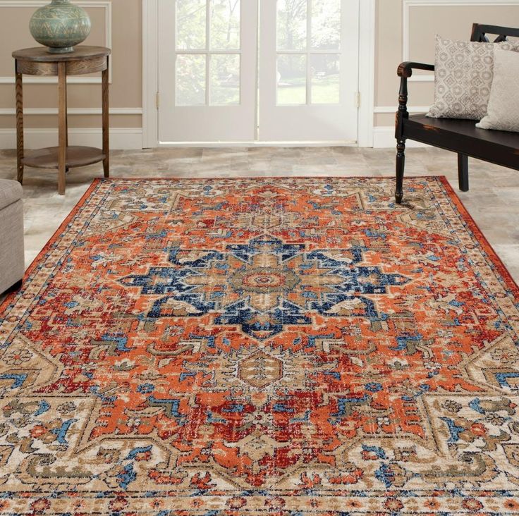 an orange and blue rug in a living room