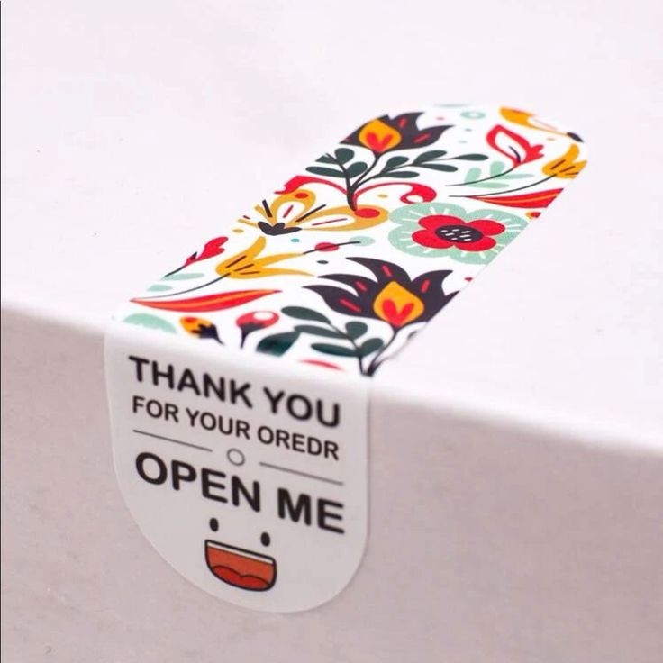 a thank you for your order sticker on the back of a white tablecloth