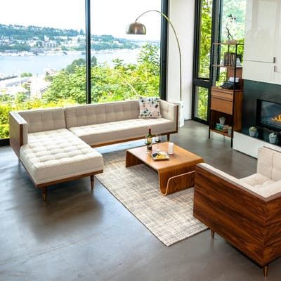 a living room filled with furniture and a fire place in front of a large window