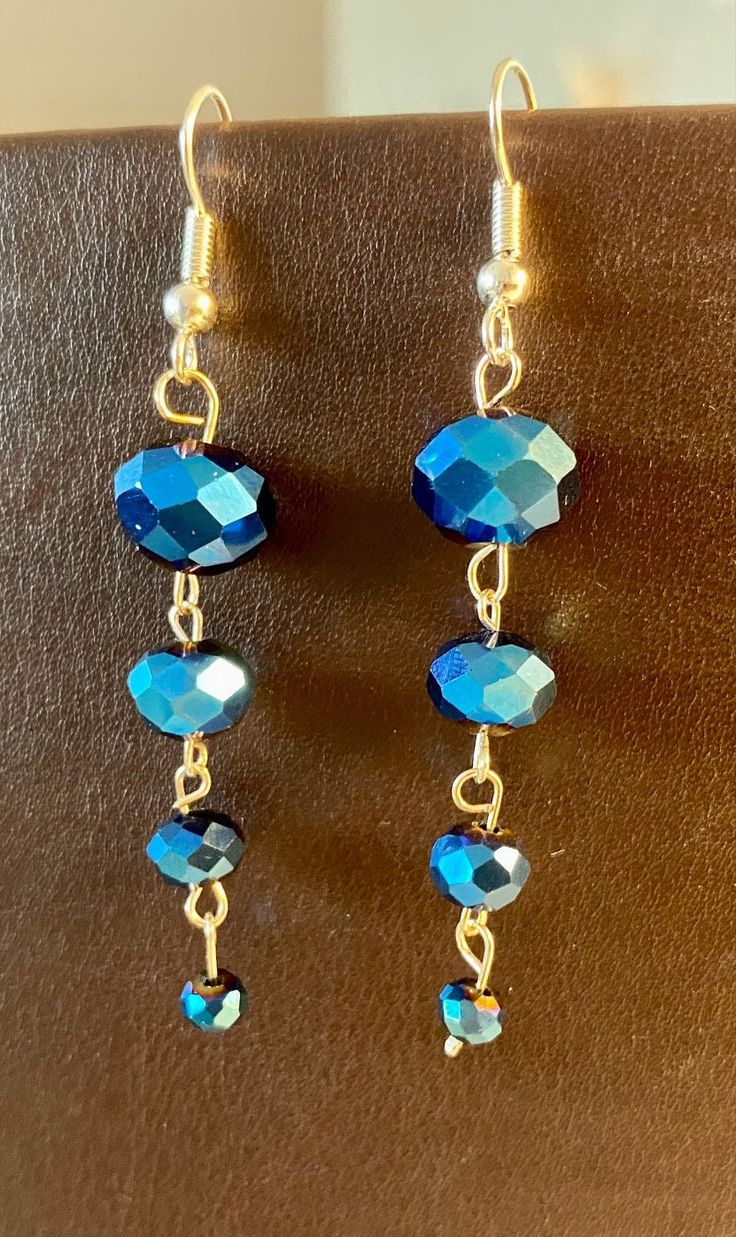 two pairs of blue glass beads hanging from gold plated earwires