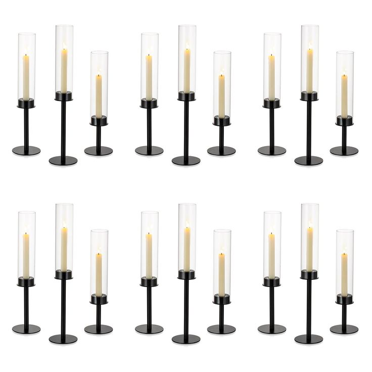 eight candles are arranged in rows on black bases