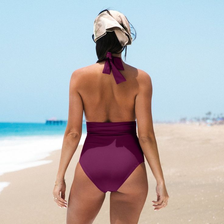 Our Plunge Ruched Backless Halter One Piece Swimsuit for women looks great on every body! This bathing suit features a deep v-neck, ruching at the bust and padded cups for added support. With its solid pattern and V-neckline design, this one piece swimsuit exudes elegance and charm, making it the perfect choice for a feminine and stylish look that captures the essence of summer. Product Code: ASL0103YB/ASL0103AA/DAA12E2G001TT/DAA12E2G001WW/DAA12E2G001EE/CAA12E2J003RR/DAA12E2G001JJ/DAA12E2G001UU/ Purple V-neck Swimwear With Lined Body, Purple Bodysuit For Poolside During Beach Season, Chic Purple Swimwear For The Beach, Chic Purple Swimwear For Vacation, Chic Fitted Purple Swimwear, Chic Purple Sleeveless Swimwear, Purple One-pieces For Poolside And Beach Season, Purple One Pieces For Poolside And Beach Season, Purple One Piece For Poolside And Beach Season