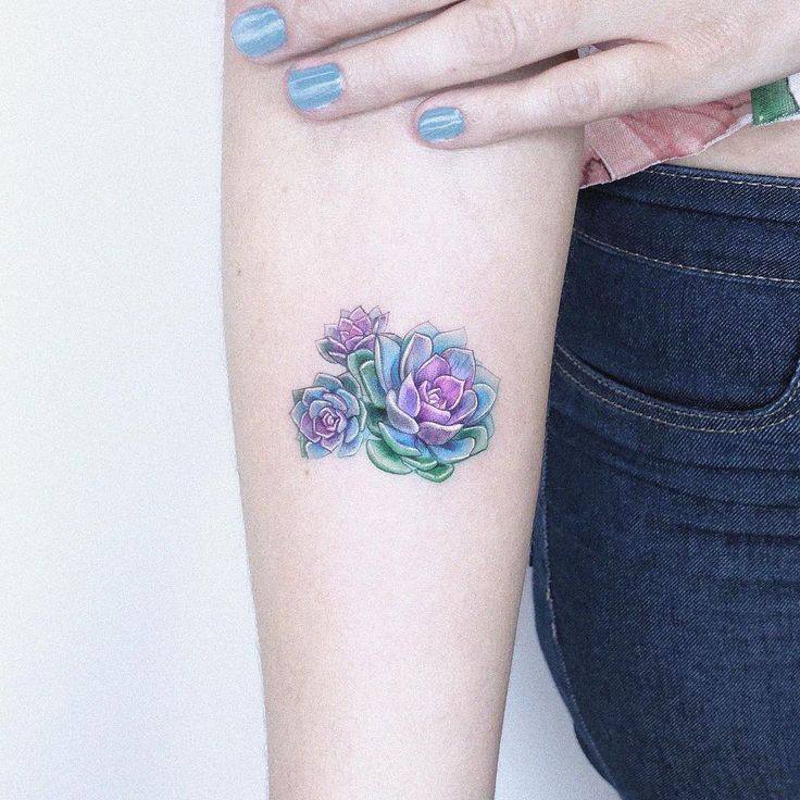 a woman's arm with a flower tattoo on the left side of her body