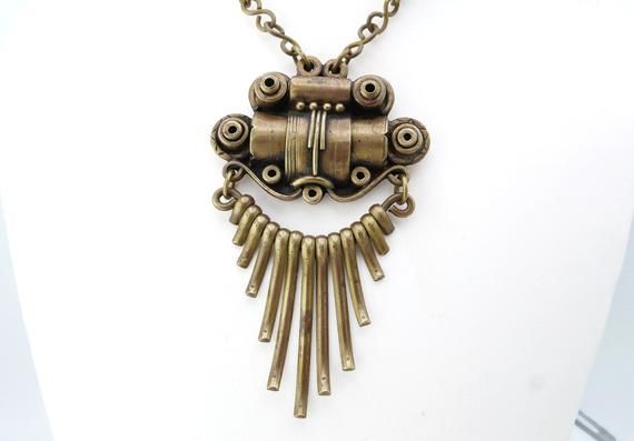 Unusual vintage 1970s necklace! Somewhere between Brutalist, Steampunk, Art Deco, and modernist.Very well made, I wish I knew who the artist is. Chain measures 23 1/2” - Pendant is 3 3/4” x 2 1/4.” Condition - excellent, no damage or repairs. Retro Metal Necklaces For Jewelry Making, Retro Soldered Metal Jewelry, Retro Metal Pendant Necklace, Retro Pendant Metal Necklace, Retro Metal Necklaces With Large Pendant, Retro Metal Necklace With Large Pendant, 1970s Necklace, Modernist Ring, Purple Jade