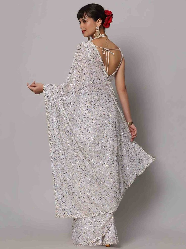 Wear this designer saree with amazing trending sequin work to create fashion statements. This sequin saree can be adorned at parties and receptions. With its beautiful white georgette material and heavy sequin work, this saree is bound to turn heads wherever you go.
The saree features a stunning sequin floral borderwork, adding an elegant touch to the overall design. The heavy sequin work on both the saree and blouse enhances its beauty and makes it a perfect choice for special occasions.
Measur Glamorous Sequined Pre-draped Saree For Festivals, Party Wear Pre-draped Sequined Saree For Festivals, Semi-stitched Sequined Pre-draped Saree For Reception, Glamorous Embellished Pre-draped Saree For Celebrations, Festive Sequined Pre-draped Georgette Saree, Semi-stitched Sequined Georgette Blouse Piece, Semi-stitched Georgette Blouse Piece With Sequins, Glamorous Georgette Dupatta For Reception, Fitted White Blouse Piece For Party Wear