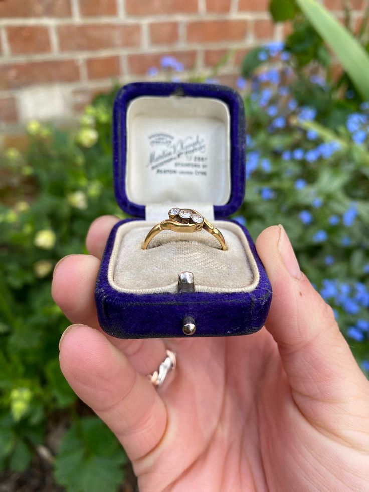 This listing is for a gorgeous vintage 18ct yellow gold diamond trilogy ring.  ✨DETAILS✨ ✨Hallmarks✨ 18ct gold, makers mark HS ✨Gemstone✨ Three round cut sparkling diamonds  ✨Size✨ UK size O1/2, US size 7.75 (resizing possible if needed) ✨Measurements✨ the face of the ring measures 12x6mm ✨Weight✨ 2.3 grams ✨Condition✨ Good vintage condition ✨EXTRA INFORMATION✨ ✨ Unless otherwise stated all vintage/antique boxes pictured are for display purposes only and are not included in the sale. All ring orders come gift wrapped in a new luxury ring box. We do usually have a selection of vintage/antique boxes available for purchase in our shop if you would prefer an older box. ✨RESIZING - We are able to offer resizing with our experienced local jeweller if needed. The resizing process takes approximat Victorian Three-stone Round Cut Ring, Victorian Three Stone Round Cut Ring, Antique Three-stone Diamond Promise Ring, Antique Three Stone Diamond Promise Ring, Vintage Yellow Gold Three Stone Rings, Vintage Three Stone Diamond Ring Gift, Victorian Gold Three Stone Ring, Victorian Gold Three-stone Ring, Victorian Style Diamond Ring With Single Diamond As Gift