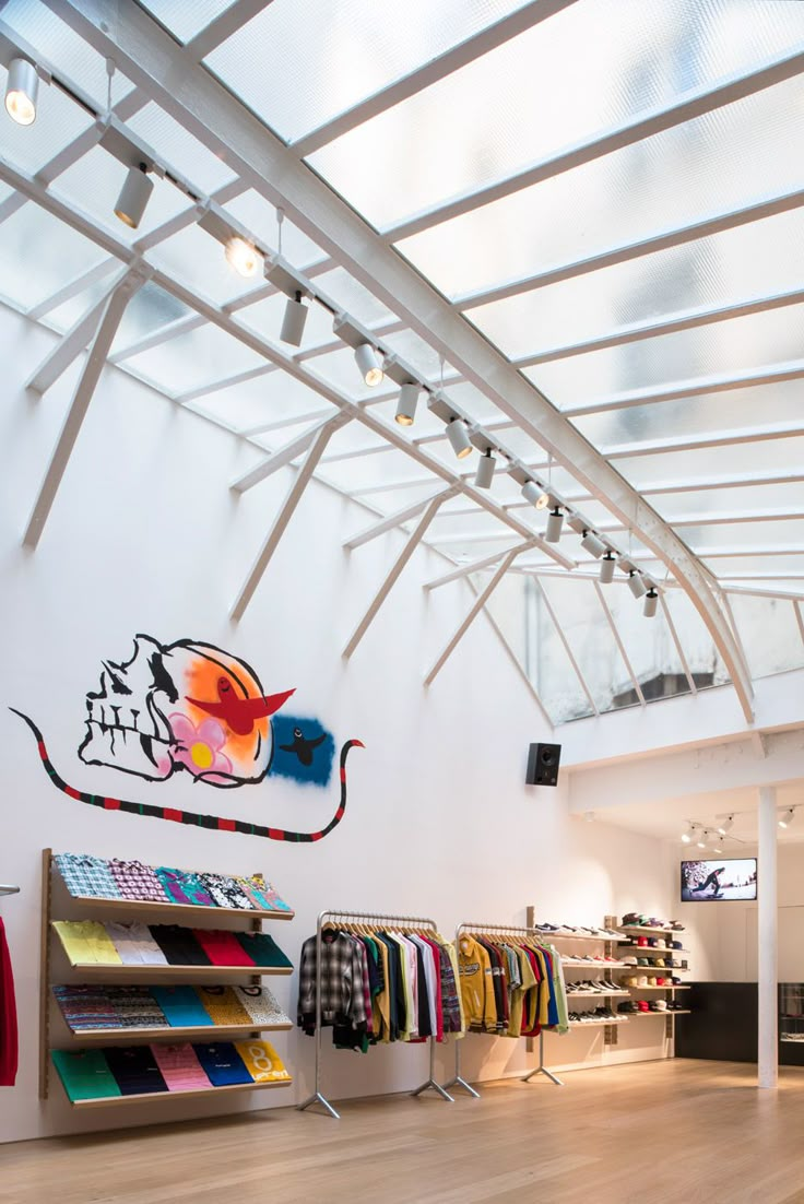 the inside of a clothing store with wooden floors