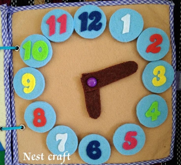 a clock made out of felt with numbers on it