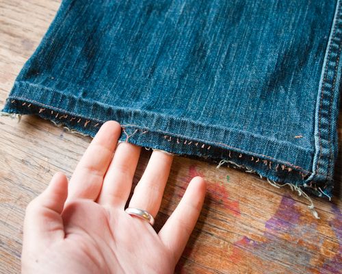 someone's hand on the edge of a pair of jeans