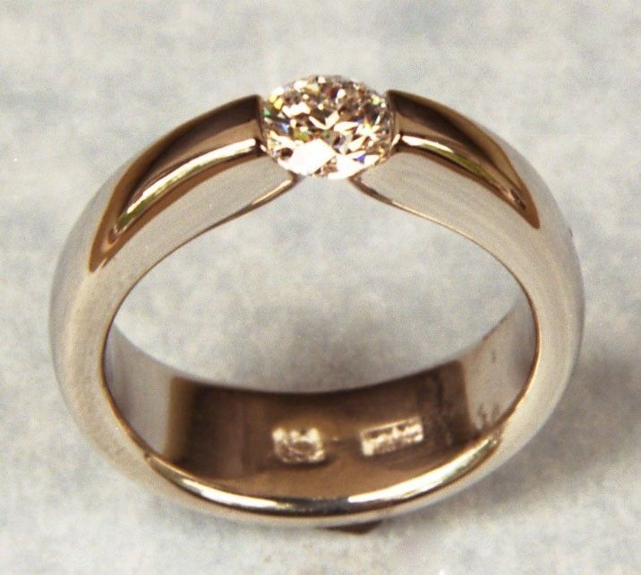 a gold ring with a diamond in the center