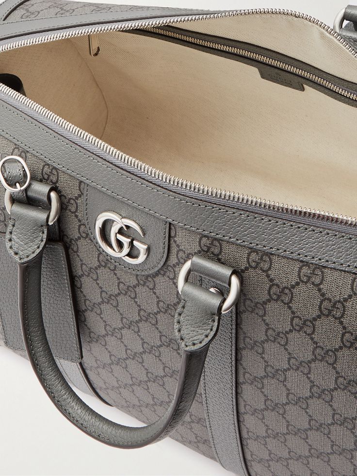 Gucci's versatile 'Ophidia' duffle bag works well for a weekend getaway or as an airplane carry-on. Made in Italy from the label's 'GG Supreme' coated-canvas, it's trimmed with leather and has sleek silver-tone hardware. The adjustable shoulder strap can be detached if you prefer to use the two top handles. Designer Luggage With Sleeve For Daily Use, Designer Luggage With Luggage Sleeve For Daily Use, Designer Duffle Bag For Daily Use, Luxury Monogram Canvas Satchel For Travel, Luxury Monogram Canvas Travel Bag For Daily Use, Monogram Canvas Travel Bag For Daily Use, High-end Travel Bag With Dust Bag, High-end Travel Bag With Dust Bag Included, High-end Travel Bag With Leather Trim