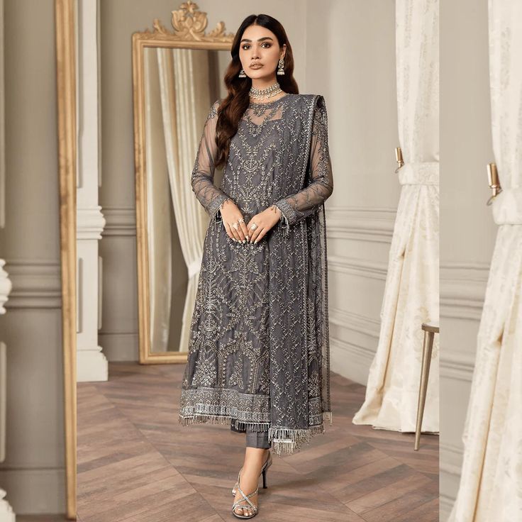 Fabric: Finest Quality Net Same As Picture: Yes 100% Imagine a garment that captures the essence of bold sophistication and timeless elegance. Our Hand Embellished Dark Gray Shalwar Kameez, also known as the Storm Grey Salwar Suit, is a masterpiece designed to make you feel like royalty at any special occasion. Perfect for bridal wear, Pakistani fashion enthusiasts, and lovers of luxury ethnic wear, this exquisite piece is curated on a grey base and adorned with matte silver sequins, creating a Elegant Long Sleeve Churidar With Intricate Embroidery, Elegant Churidar With Dabka Work, Elegant Long Sleeve Zari Work Churidar, Elegant Long Sleeve Churidar With Zari Work, Elegant Full-length Georgette Churidar, Elegant Long Sleeve Georgette Churidar, Elegant Long Sleeve Churidar For Designer Wear, Elegant Long Sleeve Unstitched Churidar, Elegant Embroidered Long Sleeve Churidar