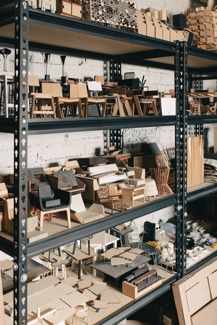 the shelves are filled with wooden furniture and boxes