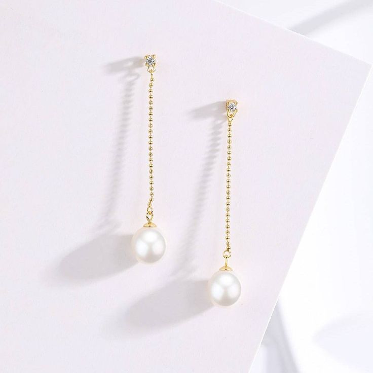 Elevate your ensemble with the exquisite elegance of our Natural Freshwater Pearl Long Earrings. Crafted with AAAA-grade natural freshwater pearls, these earrings boast a luxurious allure. Set in s925 silver with stunning 18K gold vermeil details, they exude sophistication and charm. Perfect for special occasions, these earrings offer a timeless and opulent look that enhances any outfit. The top stud features a sparkling cubic zirconia, while a long bead drop chain culminates in a lustrous 8-9mm Elegant Pearl Earrings With Pearl Chain, Elegant Pearl White Earrings With Pearl Chain, Elegant Pearl White Pearl Chain Earrings, Luxury Dangle Earrings With Pearl Chain, Akoya Pearl Drop Earrings, Luxury Pearl Drop Dangle Earrings, Elegant Pearl Chain Dangle Earrings, Elegant Dangle Pearl Chain Earrings, Luxury Dangle Pearl Earrings