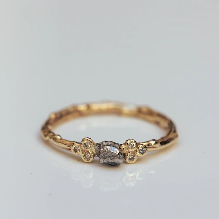 "14k gold branch ring with a beautifully delicate piece of \"campo del Cielo\" meteorite accompanied with 3 small white diamonds on both sides. A combination of two of our lovable collections into one unique harmonic design, with balanced composition and perfect gentle proportions. This specific piece is a one-of-a-kind, and the meteorite is slightly different in each ring. It can be done in this design specifically for you by order; it can feature specific characteristics, unique and individual to this work according to your wishes.  * Material: 14K Solid Gold * Gold Color: Yellow Gold, White Gold, Rose Gold, Silver * Number of diamonds: 3 on each side. * Diamonds size: 1.4mm each * Top top light brown * All of our jewelry is handmade, so there might be a slight difference between each pi Meteorite Engagement Ring Women, Nature Engagement Rings, Meteorite Engagement Ring, Organic Jewellery, Most Beautiful Engagement Rings, Branch Engagement Ring, Delicate Engagement Ring, Unusual Engagement Rings, Handcrafted Engagement Ring