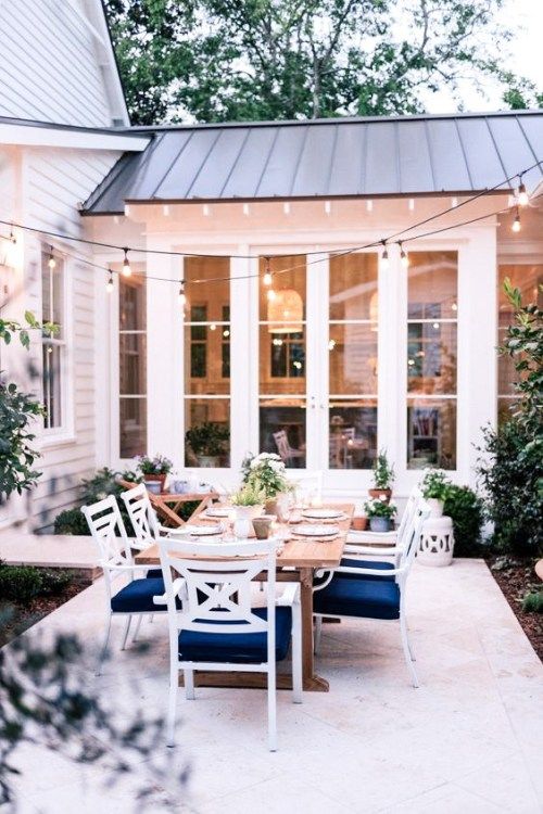 an outdoor dining area with table and chairs