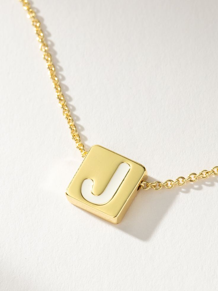 If there’s always an initial necklace in your stack, you need our Bold Letter Necklace. This block letter necklace brings a pop to your stack with its white lettering detail. Layer with our Textured Stud Necklace for a simple, everyday look. For a fully personalized look, shop our Initial Jewelry. | Gold Bold Letter Block Pendant Necklace with Initial A | Women's Jewelry by Uncommon James Minimalist Everyday Initial Necklace With Letter Beads, Everyday Initial Necklace With Letter Beads, Everyday Initial Pendant Name Necklace With Letter Beads, White Initial Pendant Charm Necklace, White Initial Pendant Charm Necklaces With Letter Beads, White Initial Pendant Charm Necklace With Letter Beads, Everyday White Initial Pendant Charm Necklaces, Trendy White Letter Jewelry, Trendy White Letter Shaped Jewelry