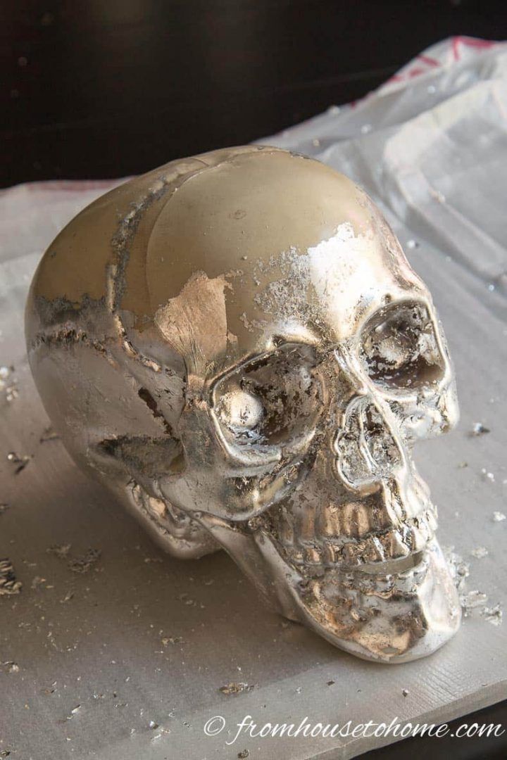 a silver skull sitting on top of a table