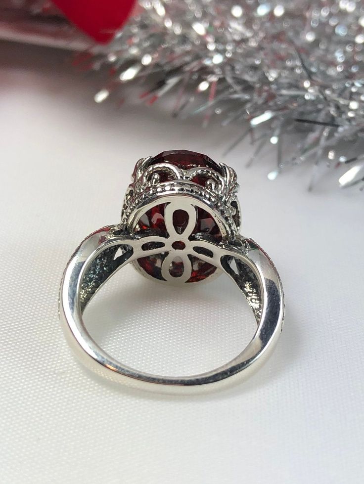 Garnet Ring Dragon Design #133 MADE TO ORDER This lovely sterling silver filigree ring is set with a stunning approximately 6ct Red Garnet CZ, {6ct Natural Garnet gemstone also available, see last picture in set}. The oval-cut Garnet gemstone is 14mm long by 10mm wide. The ring is 8mm off the finger. Notice the detailed design of the silver filigree setting and band. This is an exquisite rendition of a Gothic/Renaissance filigree ring... and is ready to wear. A ring gift-box is included. Feel fr Oval Garnet Jewelry With Intricate Design, Exquisite Silver Round Ruby Ring, Exquisite Silver Ruby Ring, Garnet Rings With Intricate Design, Elegant Silver Ruby Ring With Round Stone, Formal Oval Ruby Ring With Stone Setting, Ornate Garnet Round Rings, Ornate Round Garnet Rings, Classic Oval Crystal Ring With Stone Setting