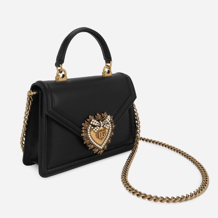 The Devotion Small Bag in Black bag from the D&G line is made of fine calfskin and characterized by the exclusive bejeweled heart closure and strap inspired by the manufacture of fine jewelry. Luxury Crossbody Shoulder Bag With Pearl Handle, Luxury Shoulder Bag With Pearl Handle, Luxury Bag With Chain Strap As Gift, Luxury Bags With Chain Strap As Gift, Luxury Bags With Chain Strap For Gift, Luxury Clutch Shoulder Bag With Pearl Handle, Luxury Evening Bag With Detachable Handle For Gifts, Luxury Pearl Handle Shoulder Bag, Luxury Black Bag With Pearl Handle