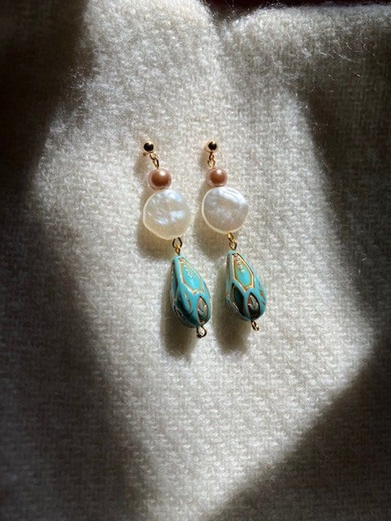 A harmonious blend of classic elegance and vibrant color. --- The combination of the classic pearl-like beads and the vibrant turquoise creates a striking contrast. The pearl-like beads symbolize timeless elegance, while the turquoise adds a touch of bohemian charm and color. --- These earrings are versatile enough to be worn with both casual and formal outfits. They add a touch of elegance to everyday wear and can also complement evening attire or special occasion outfits. --- Overall, these pe Pearl Bead Earrings, Dainty Dangle Earrings, Formal Outfits, Special Occasion Outfits, Earrings Dainty, Beaded Dangle Earrings, Earrings Vintage, Bead Earrings, Evening Attire