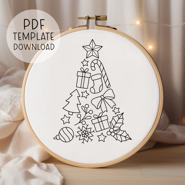 a cross stitch christmas tree with presents on it