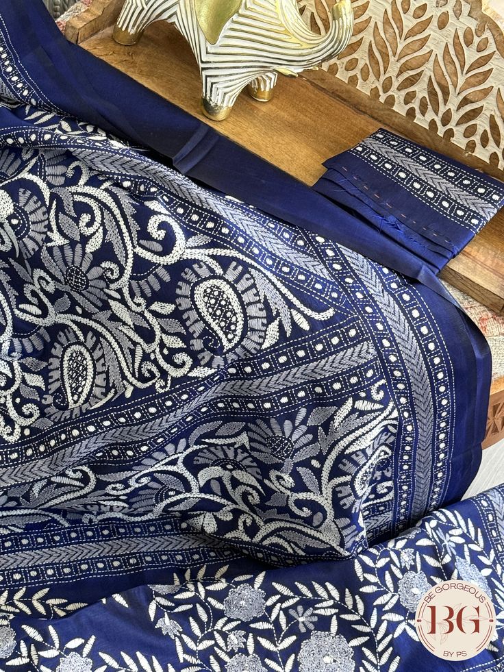 Indulge in luxury and elegance with our Kantha Stitch Saree on bangalore silk - blue. Crafted with intricate and delicate Kantha stitching, this saree is a true masterpiece. Pure bangalore silk creates a lustrous and smooth drape, while the beautiful blue color adds a touch of sophistication. Elevate your style with this exclusive saree. Kantha Stitch on bangalore silk - blue Saree comes with a blouse piece. Fall and pico done. Fully stitched blouse shown in pictures is optional and can be purchased seperately from our blouses and croptops section. For saree video please connect with us on whatsapp @469-937-0606 Ready to be shipped in USA from San Diego, California. All pictures are original pictures. Colors may slightly vary due to pic resolution. Blue Art Silk Pre-draped Saree With Traditional Patterns, Traditional Blue Pre-draped Saree With Dupatta, Blue Silk Pre-draped Saree For Traditional Ceremonies, Traditional Blue Pre-draped Saree For Festivals, Blue Raw Silk Pre-draped Saree For Festivals, Festive Blue Art Silk Pre-draped Saree, Blue Katan Silk Pre-draped Saree, Blue Katan Silk Pre-draped Saree With Zari Work, Semi-stitched Blue Saree With Dupatta