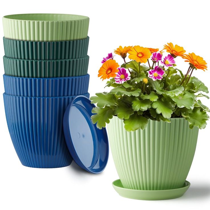 three different colored flower pots sitting next to each other