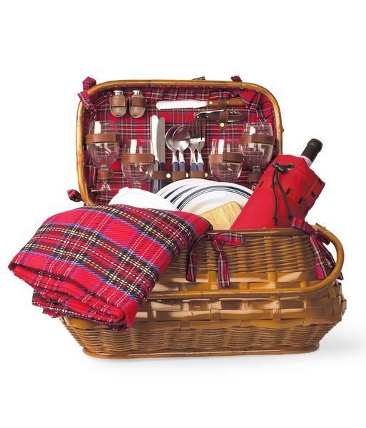 an open picnic basket with utensils and other items in it on a white background