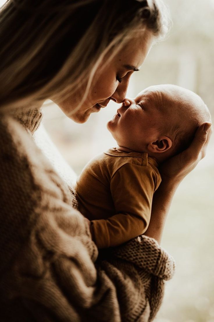 a woman holding a baby in her arms