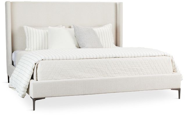 a bed with white linens and pillows on it's headboard, against a white background