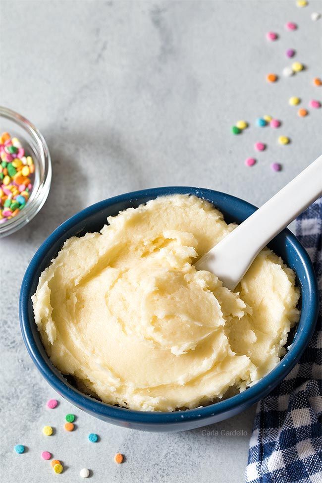 a blue bowl filled with mashed potatoes and sprinkles next to a plate