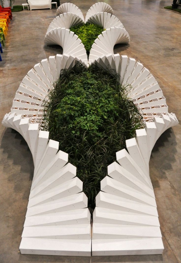 several white umbrellas are arranged in the shape of a heart, with grass growing between them