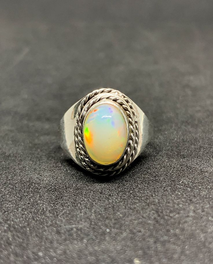 Natural Ethiopian Opal Silver Ring, 925 Solid Sterling Silver Ring, Cabochon Stone Ring, Bridal Jewelry, Wedding Rings, Vintage Opal Ring, Christmas gifts, Anniversary Gifts, Gift for Her. Description Gemstone: Opal Gemstone Color : Multi Color Gemstone Shape: Oval Gemstone : Size 8 x 10 mm Ring Weight : 3.0 mm Metal: Sterling Silver Material: 925 Sterling silver, Polished, Gemstone. Stone Creation: Natural Metal Purity: 925 parts per 1000 Country/Region of Manufacture: India Brand : Brand: Tanu Shree Jewellers Setting Type: Bezel Available in 925 sterling silver. This is Solid Handmade Sterling Silver Ring with Natural Gemstone. We are using Pure 925 (Stamped) Sterling Silver with Gemstone Jewelry, our jewelry designs are Handmade and some design are casting. We do handmade and casting wo Classic Handmade Opal Ring, Classic Handmade Round Opal Ring, Handmade Classic Opal Ring, Classic Cabochon Opal Ring As Gift, Classic Cabochon Opal Ring Gift, Classic Gift Opal Ring, Classic Silver Opal Ring Gift, Sterling Silver Heirloom Opal Ring, Vintage Silver Opal Cabochon Ring