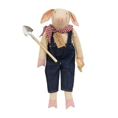 a stuffed pig holding a shovel and wearing overalls