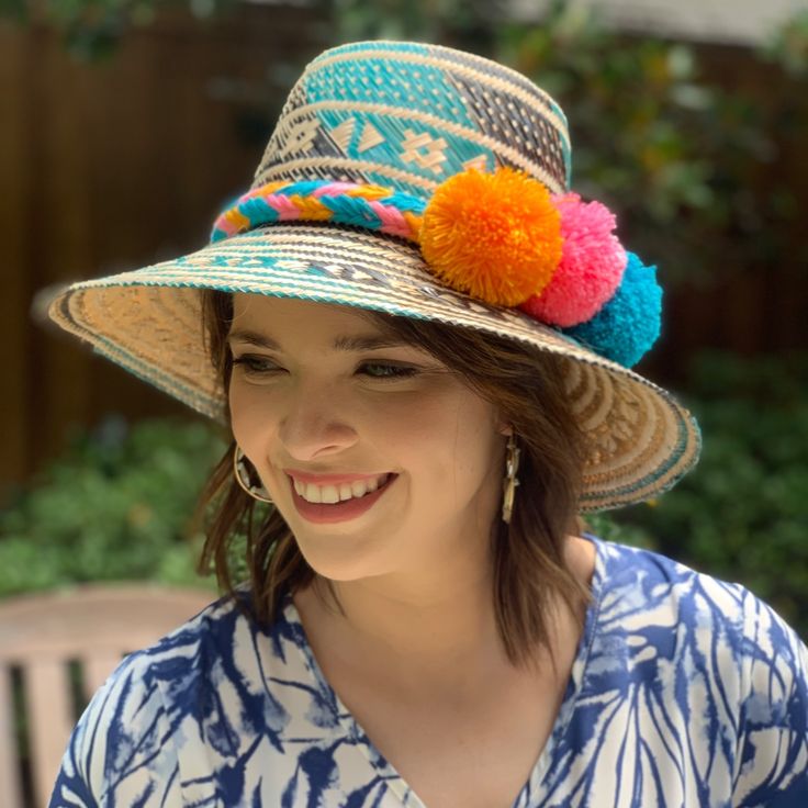 Handwoven Turquoise, Brown And Natural Straw Hat With A Wide Brim And Interior Band. Each Of Our Artisan Hats Is Unique And Takes Approximately 8-10 Hours To Hand Weave By Skilled Artisans In The Guajira Desert Of Colombia. Pair With One Of Our Handwoven Pom-Pom Hat Bands For A Fun Pop Of Color. Pom Pom Hat Bands Are Available In A Variety Of Colors And Are Sold Separately. Comment Below If You're Interested In Purchasing A Pom Pom Hat Band And We Will Let You Know What Colors We Have Available. Blue Summer Sun Hat For Festival, Blue Summer Festival Hat, Blue Summer Straw Hat For Festivals, Bohemian Blue Bucket Hat, Bohemian Blue Bucket Sun Hat, Blue Wide Brim Straw Hat For Festivals, Bohemian Green Hat For Vacation, Green Bohemian Hat For Vacation, Blue Bohemian Sun Hat For Summer