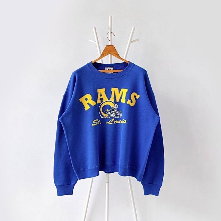 90 St. Louis Rams NFL sweatshirt/ L * PLEASE READ BEFORE PURCHASE * PLEASE consider the PHOTOS before making the decision * The images may DIFFER in appearance from the actual product because we took pictures under daylight.  * PLEASE send your PHONE NUMBER after your purchase for the shipping company to contact you X No returns X No refund Condition : 8/10 More details : stains (sleeve)/ look at the pictures  Brand : Lee Size : L Pit to pit/ Chests : 26.5/53 inches  Length : 26 inches  Material : cotton polyester  Color : blue * ALL ITEMS are VINTAGE which may show some signs of wear and tear * Due to the different display and different light, the picture may not reflect the actual color of the item * Please, remember that our items are vintage so they may show some signs of wear, tear an Throwback Fleece Sweatshirt For Fall, Throwback Fleece Sweatshirt For College, Oversized Throwback Sweatshirt For Fall, Throwback Oversized Crew Sweatshirt, Oversized Throwback Crew Sweatshirt, Oversized Crew Neck Throwback Sweatshirt, 90s Long Sleeve Sweatshirt For Fall, 90s Style Long Sleeve Fall Sweatshirt, 90s Long Sleeve Fall Sweatshirt