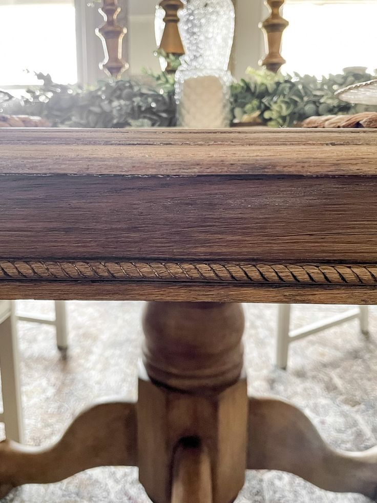 a close up of a wooden table with roped ends on the top and bottom