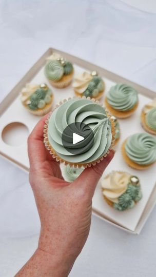 a person holding a cupcake in their hand