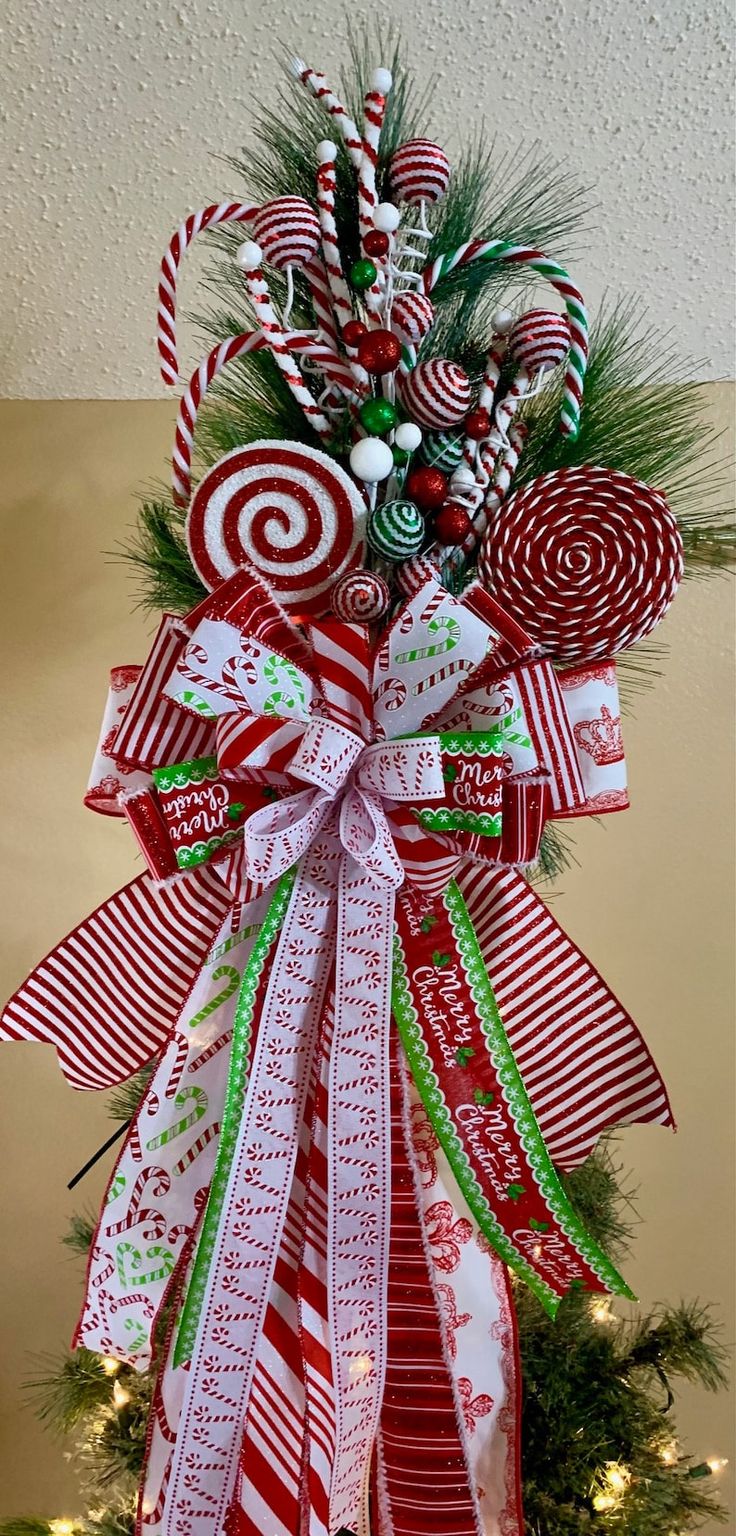 a christmas tree decorated with candy canes and ribbons